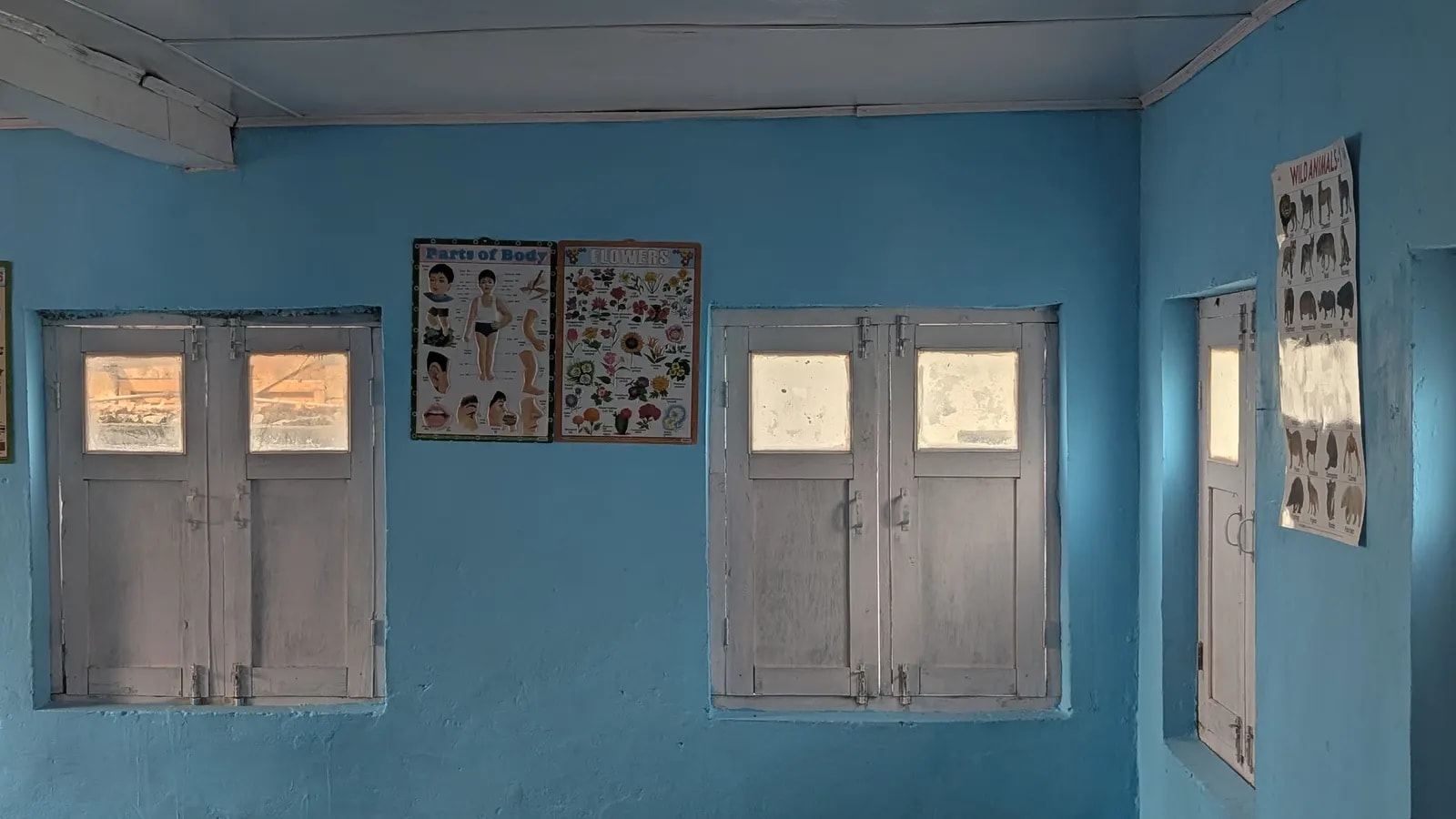 Educational charts on the freshly painted classroom walls